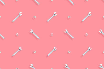 Adjustable metal wrench seamless pattern. Background from a metal wrench and nut. 