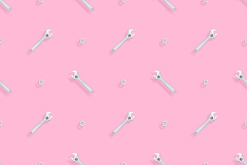 Adjustable metal wrench seamless pattern. Background from a metal wrench and nut. 