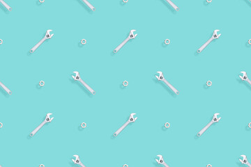 Adjustable metal wrench seamless pattern. Background from a metal wrench and nut. 