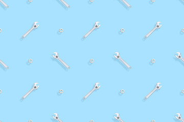 Adjustable metal wrench seamless pattern. Background from a metal wrench and nut. 