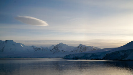 Snow covered Mountains and Icebergs in the Antarctic Peninsula on Antarctica.