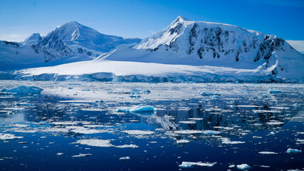 Snow covered Mountains and Icebergs in the Antarctic Peninsula on Antarctica.