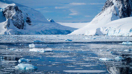 Snow covered Mountains and Icebergs in the Antarctic Peninsula on Antarctica.