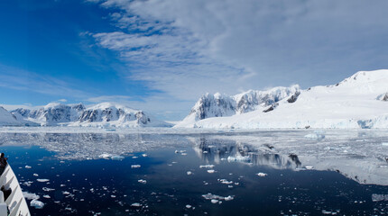 Snow covered Mountains and Icebergs in the Antarctic Peninsula on Antarctica.