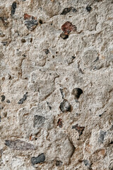 Gray old concrete surface with cracks and stones as a background texture. Copy, empty space for text