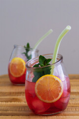 two tonic cocktails with mint, ice and lemon closeup