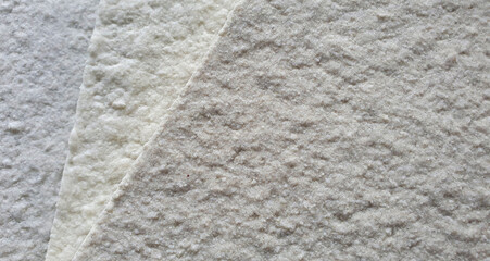 macro view of textured spray paint samples in light grey tone use for architectural facade finishing material. rough wall texture background. 