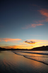 Fototapeta na wymiar Sunset at a Lush Tropical Beach Paradise with blue water of Costa Rica