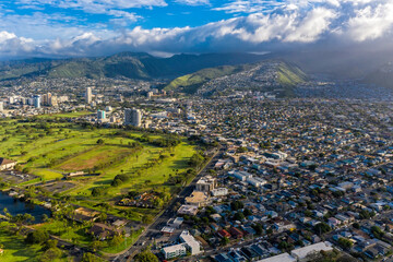 Aerial view on Honolulu suburbs located on green land and mountains, Oahu Island, Hawaii