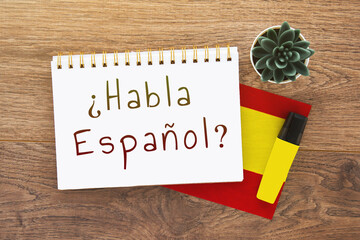 notebook with inscription do you speak spanish on spanish, pen, spain flag, marker on wooden brown...