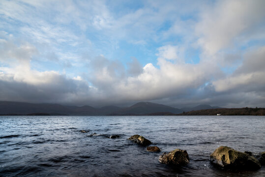 Stunning landscape image of Milarrochy Bay on Loch Lomond in Scottish Highlands with stunning Winter evening ligh