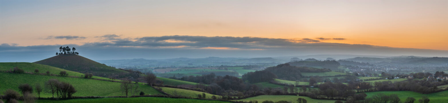 Beautiful vibrant sunrise panoramic landscape image of Colmer's Hill in Dorset on a Spring morning