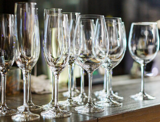 Empty white wine glasses on the table in the restaurant or bar. Table setting, close up. Glasses for alcohol. 