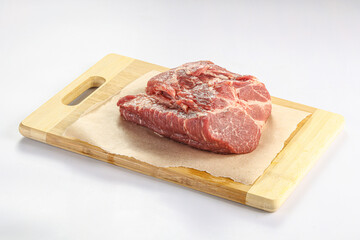 Raw pork neck over board