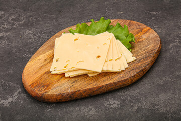 Sliced yellow cheese over board