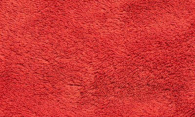 Red soft synthetic plush fleece texture background.