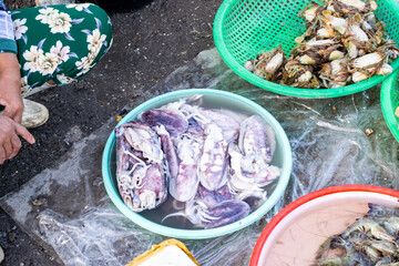 Live sea crabs and marine life lie in a tray at an Asian fish market. Vietnamese market. Sea catch.