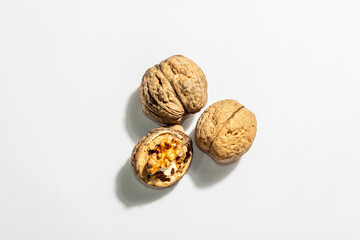 Whole and half walnuts isolated on white background