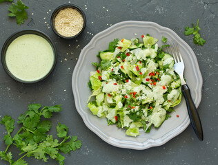 A fresh salad of green vegetables, dressed with yogurt.