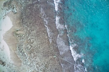Drone field of view of sea and waves forming patterns in nature, La Digue, Seychelles.