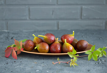 Fresh fig fruits on a wooden background.