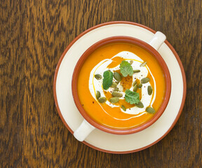 Pumpkin soup on a gray background. Selective focus.