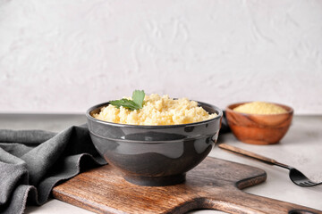 Bowl with tasty couscous on table