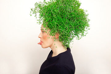 Beauty Spring Woman with Fresh Green Thyme Hair Shows Tongue. Summer Nature Girl portrait. Fashion Model