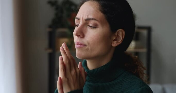 Side headshot view stressed young caucasian woman massaging temples, suffering from headache or thinking of difficult problem solution looking in distance, feeling doubtful unhappy alone at home.