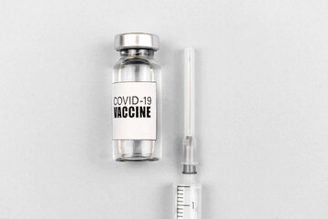 COVID-19 vaccination concept, vaccine vial with syringe on a white background, top view, healthcare...