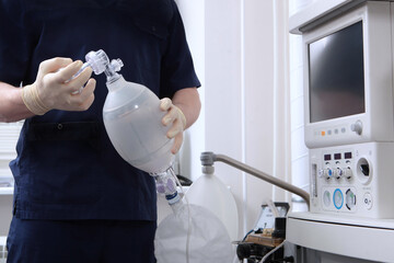 The anesthesiologist holds an ambu bag for ventilation.A spare set of medical equipment.Preparation of equipment for surgery under general anesthesia.Ambu bag.Ventilation of the lungs.