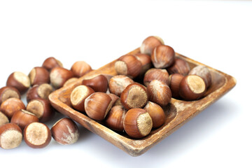 hazelnuts falling on the hazelnuts in a wooden basket