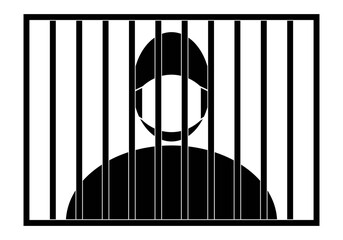 Prisionero con mascarilla detrás de los barrotes de la cárcel. En prisión con mascarilla por el Covid-19