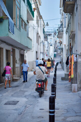 Obraz premium During their summer vacation, family and friends stroll through one of the Mediterranean seaport cities