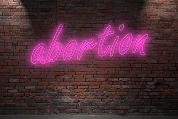 Obraz premium Neon abortion (in german Abtreibung) lettering on Brick Wall at night