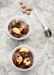 Profiteroles served in tubs with chocolate sauce