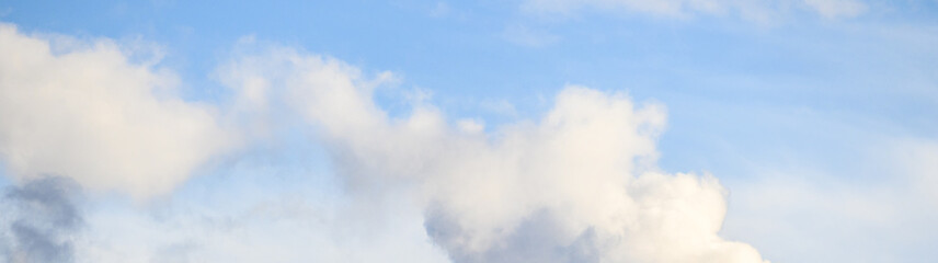 Beautiful cloudscape of puffy clouds in shades of white, blue, and gray, as a nature background
