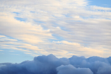 Cloudscape both with light and airy clouds, and ominous dark clouds, as a nature background
