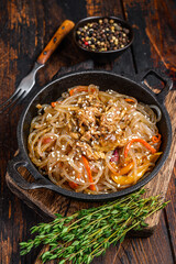 Soy glass noodles with shiitake mushrooms and chicken meat. Wooden background. Top view