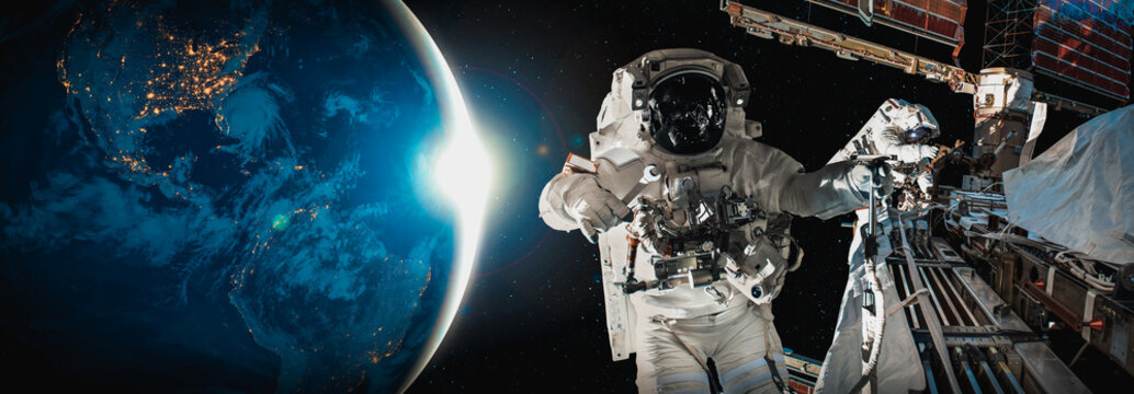 Astronaut spaceman do spacewalk while working for space station in outer space . Astronaut wear full spacesuit for space operation . Elements of this image furnished by NASA space astronaut photos.