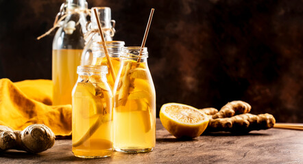 Fermented Kombucha Healthy Drink With Raw Ginger And Lemon in glass bottles.Tea Ready to Drink