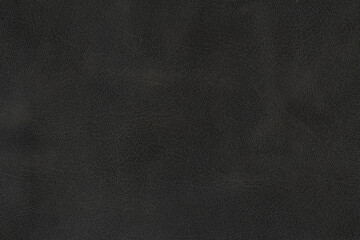 Black textured smooth leather surface background, small grain