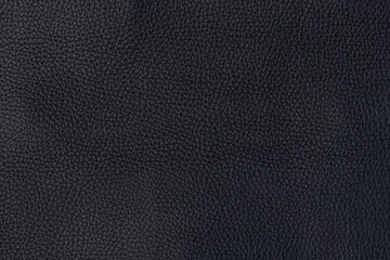 Black textured smooth leather surface background, large grain