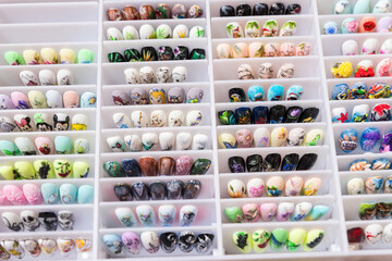 a set of various samples of nails for extension with various patterns. portfolio of the master manicurist.