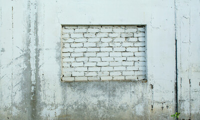 Naklejka premium Square hole in the concrete wall with bricked-in. The background of the despair of the limitation of the species is not freedom.