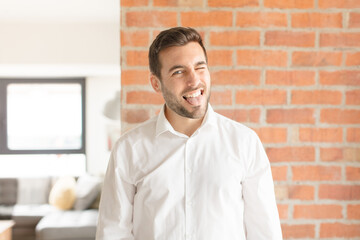 handsome businessman with cheerful, carefree, rebellious attitude, joking and sticking tongue out,...