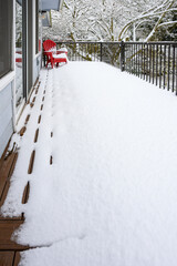 Winter storm, residential deck covered in fresh snow in a winter wonderland
