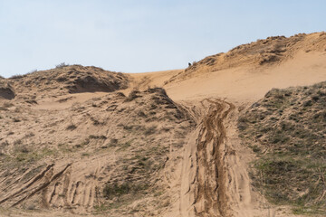 tracks from the wheels of cars on the sandy road. desert road