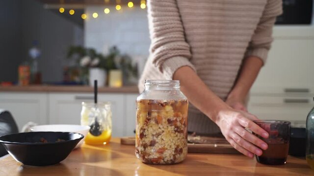 Woman cooking at home kutia - traditional ukrainian orthodox christmas food. slow living, merry season. 