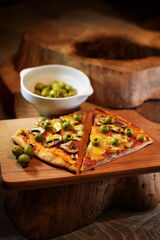 pizza with olives on a wooden board
